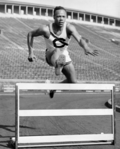 Meredith C. Gourdine jumping over a hurdle